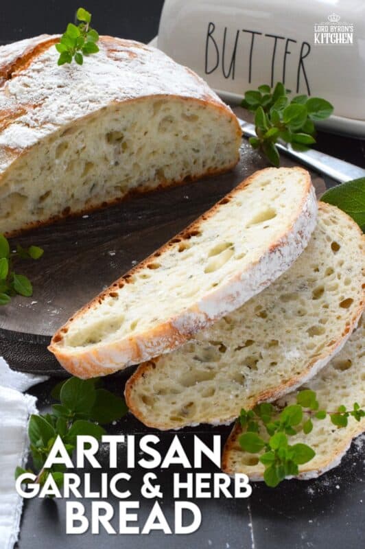 Freshly baked homemade bread is the ultimate comfort food.  There really is nothing like it!  Artisan Garlic and Herb Bread is one of the most delicious and easiest breads you’ll ever make! Loaded with fresh chopped garlic and herbs, this bread is quite aromatic and very savoury! #bread #noknead #dutchoven #homemade #garlic #herbs