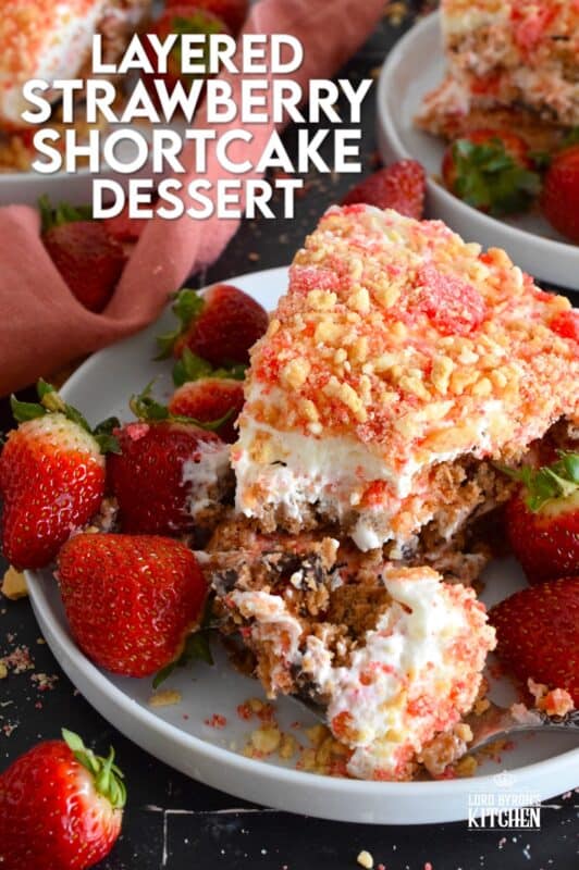 A no-bake dessert that is best prepared in advance and refrigerated overnight, this delicious Layered Strawberry Shortcake Dessert uses homemade strawberry shortcake crumbs, chocolate chip cookies, and a cream cheese-based cream topping. Serve with fresh strawberries! #strawberry #shortcake #dessert #layered #cookies #creamcheese