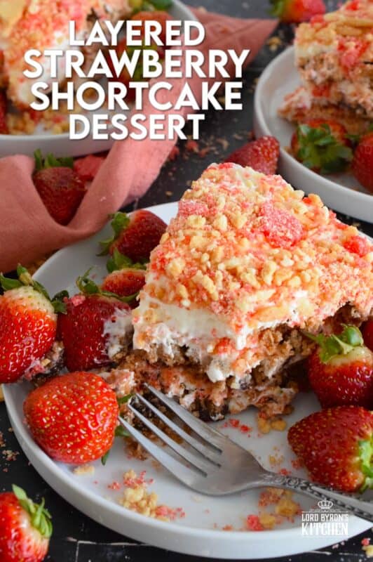 A no-bake dessert that is best prepared in advance and refrigerated overnight, this delicious Layered Strawberry Shortcake Dessert uses homemade strawberry shortcake crumbs, chocolate chip cookies, and a cream cheese-based cream topping. Serve with fresh strawberries! #strawberry #shortcake #dessert #layered #cookies #creamcheese
