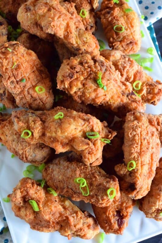 Forget those Breaded Chicken Wings in the frozen section of your local grocery store! This homemade version has better flavour, more crunch, and most certainly way more bang for your buck. These are great just the way they are, or toss them in your favourite wing sauce! #wings #chicken #breaded #fried