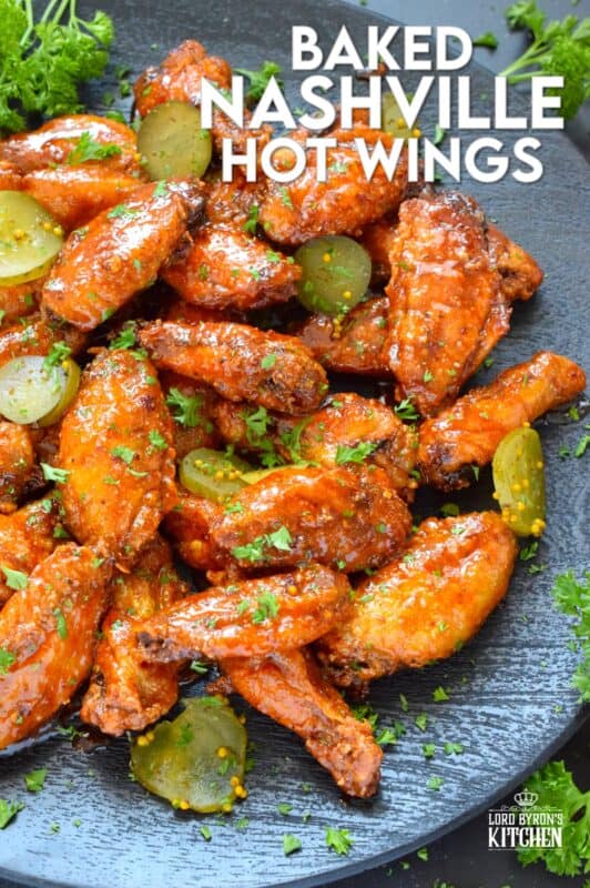 Baked to perfection with a crispy coating and a tender and juicy interior, these wings are drenched in a hot sauce comprised of cayenne, chili, garlic, onion, and melted butter, Baked Nashville Hot Wings also have an optionally sweet honey component! Plate these wings with sweet pickle slices for a cooling crunch! #baked #nashville #hot #chicken #wings #sticky