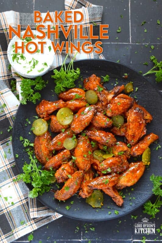 Baked to perfection with a crispy coating and a tender and juicy interior, these wings are drenched in a hot sauce comprised of cayenne, chili, garlic, onion, and melted butter, Baked Nashville Hot Wings also have an optionally sweet honey component! Plate these wings with sweet pickle slices for a cooling crunch! #baked #nashville #hot #chicken #wings #sticky