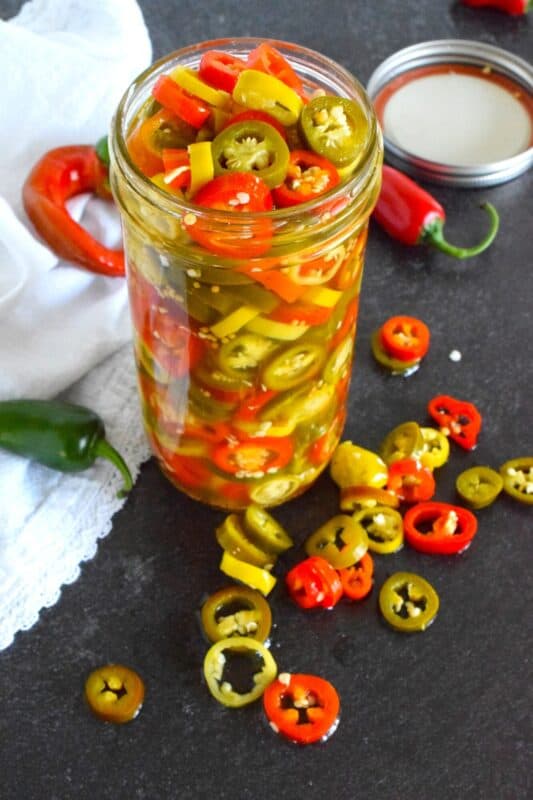 Sadly, summer does come to an end and with it, the last of your hot pepper harvest. When left with a bunch of hot peppers of mixed variety, prepare a big jar of these End of Season Pickled Peppers. No canning is required here! Fashioned with a quick pickle brine, these will keep safely in your refrigerator for two to three months! #pickled #hot #peppers #quick #brine #summer