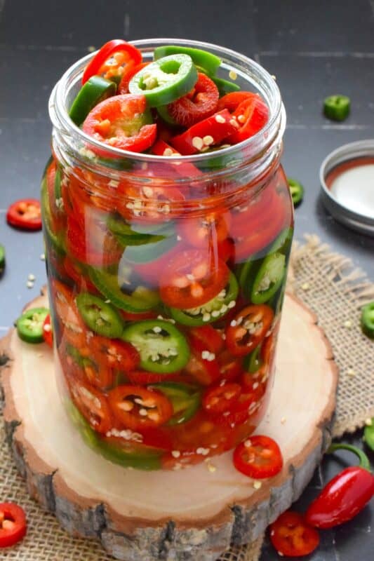 You've been missing out if you’ve never tried Quick Pickled Jalapenos! They are slightly sweet and sour but still hot and spicy! They're great on sandwiches, pizza, nachos, burgers, and scrambled eggs! All you need to prepare these are jalapenos, white vinegar, salt, sugar, and water! There is no canning equipment or knowledge required for quick pickling either! #quick #pickled #jalapenos #homemade