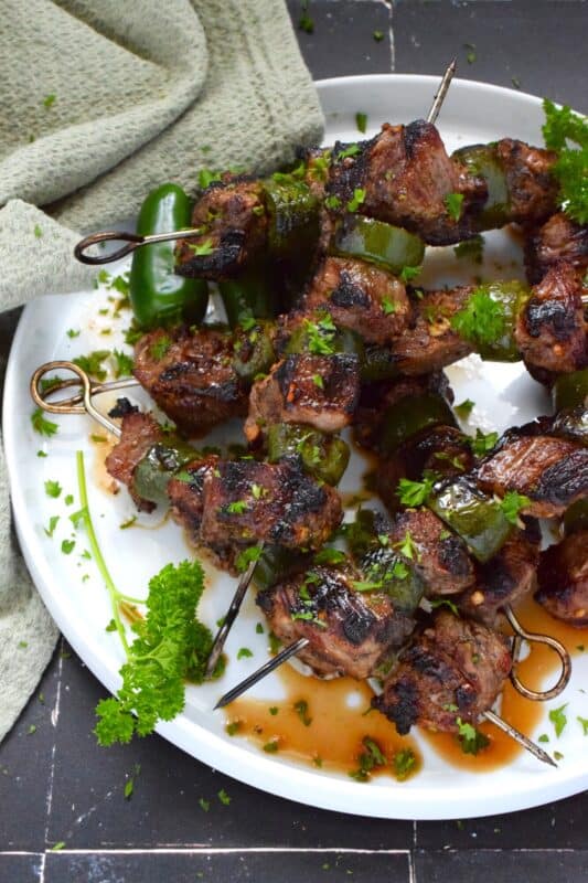 Marinated steak is skewered and grilled to perfection in this spicy Jalapeno Beef Skewers recipe. The marinade tenderizes the beef and the sliced jalapenos add flavour and spice. Quickly grilled over high heat, this beef is nicely browned and charred on the outside with a perfectly medium-cooked interior. #beef #steak #bbq #grilled #skewers #jalapeno
