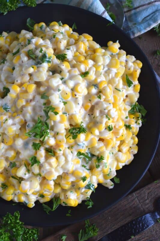 Easily transform frozen corn into the most delicious side dish in twenty minutes. Stovetop Cream Cheese Corn is side dish perfection! Watch the cream cheese and milk melt together with the corn to create a very tasty side dish in 20 minutes flat! #stovetop #cream #cheese #corn #side #dish