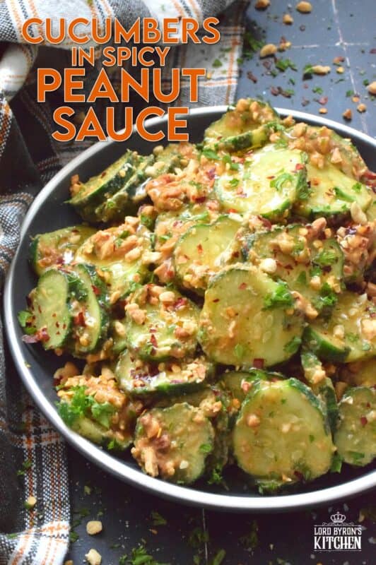 Fresh cucumbers are sliced and tossed in a quick and easy homemade nutty, salty, creamy, spicy, and garlicky sauce.  Toasting the peanuts first and combining them with peanut butter, soy sauce, and rice vinegar makes a delicious cold side, salad, or snack.  Serve at room temperature immediately after preparing for the best results! #cucumber #peanut #peanutbutter #peanutsauce #salad #spicy