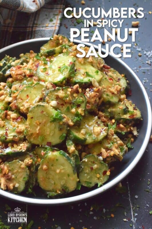 Fresh cucumbers are sliced and tossed in a quick and easy homemade nutty, salty, creamy, spicy, and garlicky sauce.  Toasting the peanuts first and combining them with peanut butter, soy sauce, and rice vinegar makes a delicious cold side, salad, or snack.  Serve at room temperature immediately after preparing for the best results! #cucumber #peanut #peanutbutter #peanutsauce #salad #spicy