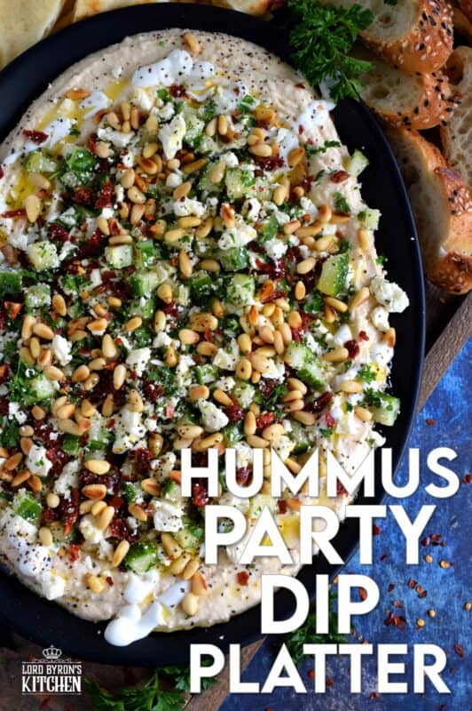 What's a party without dip? Hummus Party Dip Platter is a large, layered dip that's just perfect for entertaining a crowd. This all-in-one dip has hummus, sour cream, pine nuts, sun dried tomatoes, cucumbers, feta, and a few other ingredients too! Serve this on any occasion for a delicious, crowd-pleasing appetizer! #hummus #dip #appetizer #party #platter #spread