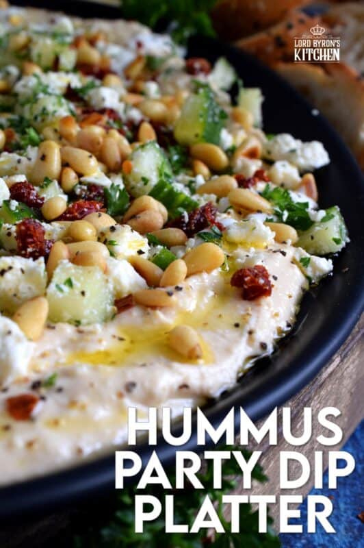 What's a party without dip? Hummus Party Dip Platter is a large, layered dip that's just perfect for entertaining a crowd. This all-in-one dip has hummus, sour cream, pine nuts, sun dried tomatoes, cucumbers, feta, and a few other ingredients too! Serve this on any occasion for a delicious, crowd-pleasing appetizer! #hummus #dip #appetizer #party #platter #spread