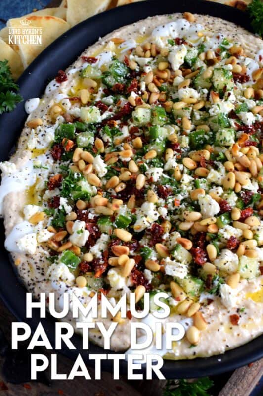 What's a party without dip? Hummus Party Dip Platter is a large, layered dip that's just perfect for entertaining a crowd. This all-in-one dip has hummus, sour cream, pine nuts, sun dried tomatoes, cucumbers, feta, and a few other ingredients too! Serve this on any occasion for a delicious, crowd-pleasing appetizer! #hummus #dip #appetizer #party #platter #spread