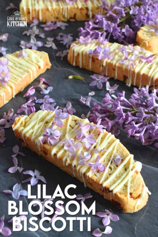 These biscotti are loaded with lilac flavour and scent.  Lilac petals are incorporated into the biscotti dough which has been sweetened with homemade lilac sugar.  Glazed and topped with more lilacs, these Lilac Blossom Biscotti are light, airy, and delicious! Super easy to make, and with their cheerful inclination, no one could resist! Treat yourself to one of these with a hot tea on a lazy Sunday afternoon. #lilac #biscotti #flowers #petals #brunch