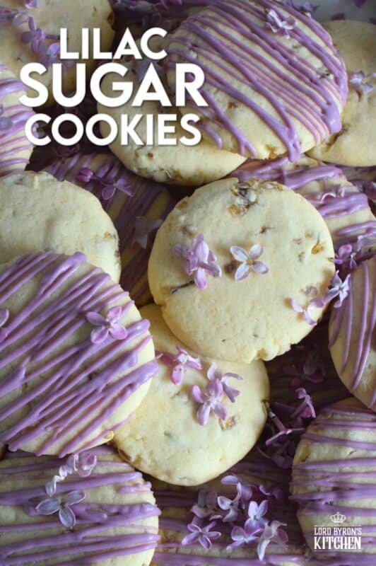 The uncomplicated and delicious sugar cookie gets a fresh, new flavour profile, and an upgrade in this Lilac Sugar Cookies recipe. A classic sugar cookie base is baked with lilac infused sugar, lilac syrup, and lilac petals. Topped with a simple glaze and sprinkled with more lilac flowers, these cookies are a great early summer treat! #lilac #sugar #cookies #baking #flowers #petals #syrup