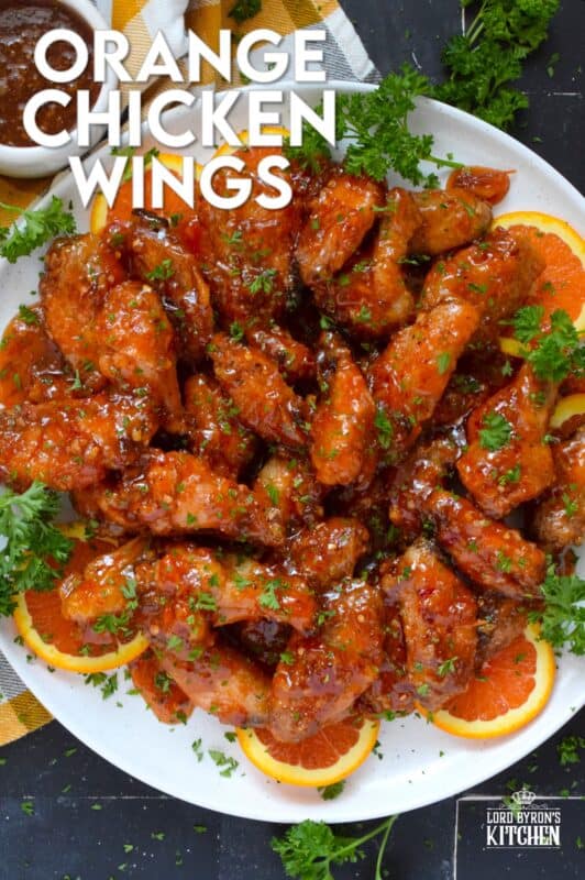 These very sticky wings are prepared with orange marmalade preserves, barbecue sauce, hot sauce, chilies, and seasonings. Orange Chicken Wings are the stickiest and most delicious wings you'll ever eat! They are baked until crispy on the outside and tossed in one of the quickest and easiest sauces! These wings don't need a special occasion; serve these any time you feel like it! #orange #wings #chicken #bbq #sauce #hotsauce