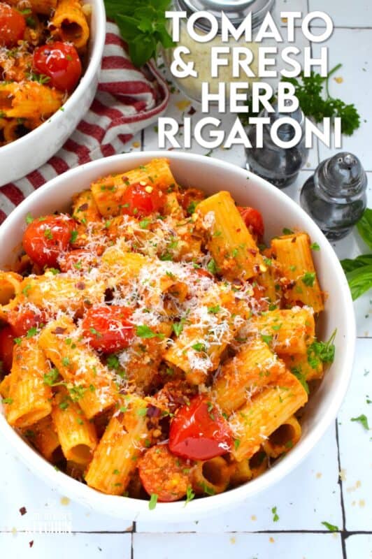Quick, easy, and delicious describes this Tomato and Fresh Herb Rigatoni! Use fresh cherry tomatoes, thyme and oregano leaves with fresh parsley to make this pasta extra special. The sauce is prepared by blistering the tomatoes in garlic and oil before tossing it with pesto.  Perfect for a weeknight family dinner, this dish takes about 30 minutes from start to finish and you get to dig in and enjoy! #pasta #herbs #fresh #tomato #30minutemeals #familymeals