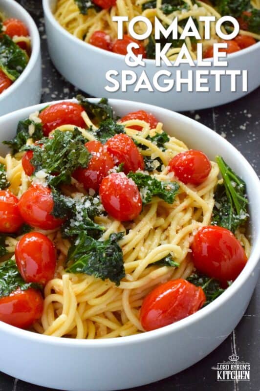 Love it or hate it, kale is an economical and delicious way to get more nutrient-dense goodness into a comforting bowl of pasta like in the case of this Tomato and Kale Spaghetti! Saute the kale in butter with garlic and shallots to make a delicious and aromatic start to this dish. Garnish with salty, nutty, grated parmesan and dig into this healthy and hearty dinner! #spaghetti #pasta #kale #vegetarian #cheesy #tomatoes