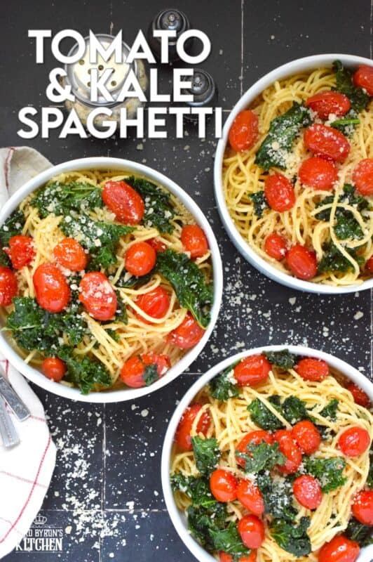 Love it or hate it, kale is an economical and delicious way to get more nutrient-dense goodness into a comforting bowl of pasta like in the case of this Tomato and Kale Spaghetti! Saute the kale in butter with garlic and shallots to make a delicious and aromatic start to this dish. Garnish with salty, nutty, grated parmesan and dig into this healthy and hearty dinner! #spaghetti #pasta #kale #vegetarian #cheesy #tomatoes