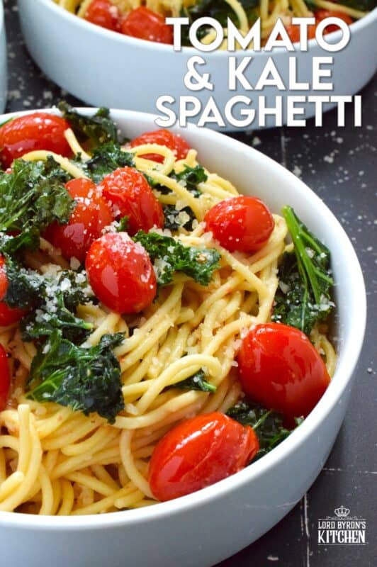 Love it or hate it, kale is an economical and delicious way to get more nutrient-dense goodness into a comforting bowl of pasta like in the case of this Tomato and Kale Spaghetti! Saute the kale in butter with garlic and shallots to make a delicious and aromatic start to this dish. Garnish with salty, nutty, grated parmesan and dig into this healthy and hearty dinner! #spaghetti #pasta #kale #vegetarian #cheesy #tomatoes