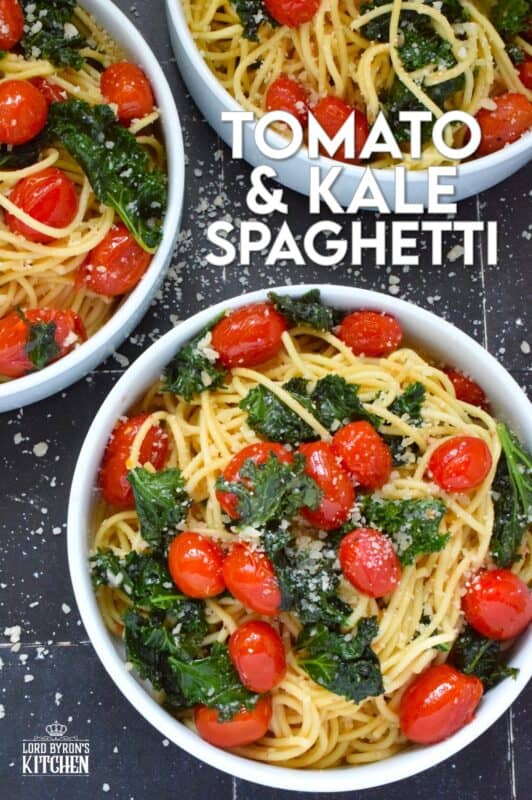 Love it or hate it, kale is an economical and delicious way to get more nutrient-dense goodness into a comforting bowl of pasta like in the case of this Tomato and Kale Spaghetti! Saute the kale in butter with garlic and shallots to make a delicious and aromatic start to this dish. Garnish with salty, nutty, grated parmesan and dig into this healthy and hearty dinner! #spaghetti #pasta #kale #vegetarian #cheesy #tomatoes