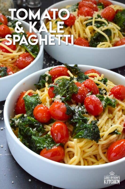 Love it or hate it, kale is an economical and delicious way to get more nutrient-dense goodness into a comforting bowl of pasta like in the case of this Tomato and Kale Spaghetti! Saute the kale in butter with garlic and shallots to make a delicious and aromatic start to this dish. Garnish with salty, nutty, grated parmesan and dig into this healthy and hearty dinner! #spaghetti #pasta #kale #vegetarian #cheesy #tomatoes
