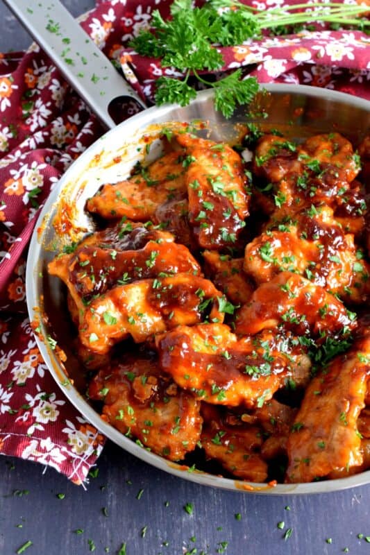 Thin cuts of pork which have been fried and then tossed in a sweet, spicy, and vinegary sauce. Peking Pork Chops are a popular Chinese buffet dish which can be easily made at home too! So fast, so easy, and so simple, these make a great weeknight family dinner option! #pork #buffet #asian #peking