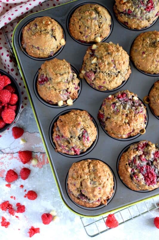 In our home, muffins are considered one of the major food groups, especially if that muffin happens to be these White Chocolate Raspberry Banana Oatmeal Muffins! These disappear before they've had time to cool down! #raspberries #banana #muffins #oatmeal #chocolate