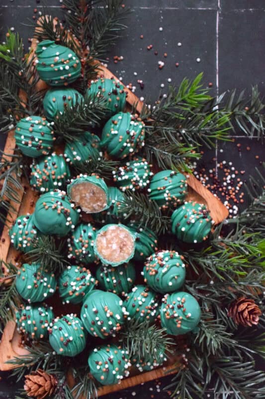 These bright and festive treats are prepared with ground nuts and sweetened condensed milk. Sweet and Nutty Christmas Balls are where candies and cookies meet to create the most delectable and rich holiday confection. It's extremely hard to eat just one of these! #nobake #candymelts #green #nuts #candy #stovetop #christmas