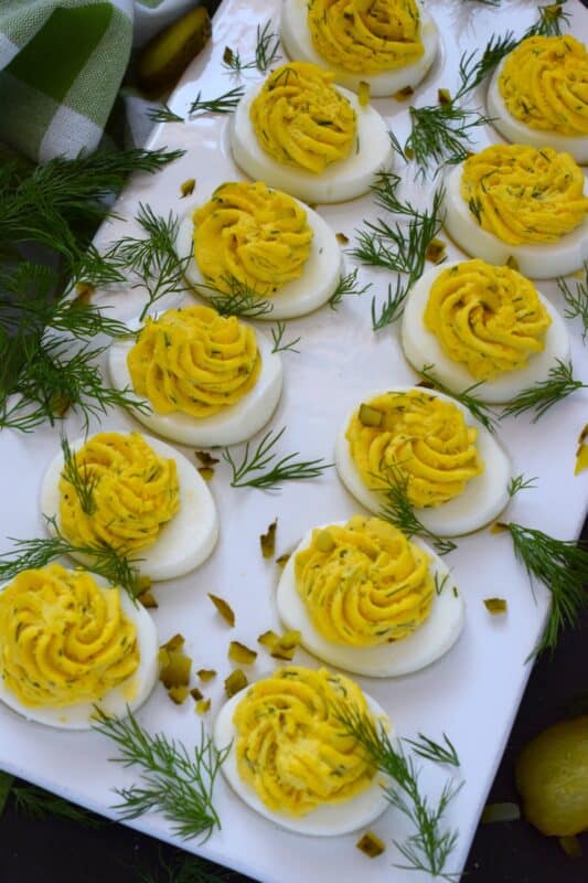Deviled Dill Pickle Eggs are so delicious and an appetizer or side that can be prepared any time of the year - not just at Easter, which is when most of us tend to prepare them! Prepared with lots of fresh dill and dill pickles, this one is obviously for the dill lover! These are great to serve at a backyard summer BBQ! #dillpickles #deviledeggs #appetizer #dill