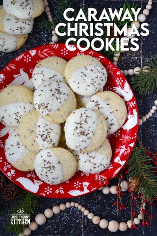These tender, soft, and moist Caraway Christmas Cookies are prepared with a basic vanilla and caraway seed-flavoured cookie dough. Dipped in melted white chocolate and sprinkled with coarse sanding sugar and more caraway, these cookies are a great addition to any holiday cookie exchange or cookie platter! #caraway #cookies #chocolate #christmas