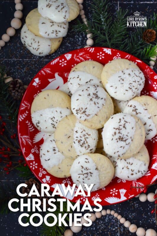 These tender, soft, and moist Caraway Christmas Cookies are prepared with a basic vanilla and caraway seed-flavoured cookie dough. Dipped in melted white chocolate and sprinkled with coarse sanding sugar and more caraway, these cookies are a great addition to any holiday cookie exchange or cookie platter! #caraway #cookies #chocolate #christmas