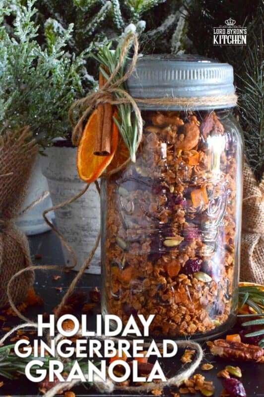 Almonds, cashews, pecans, pumpkin seeds, cranberries, and apricots help to flavour and bulk up this Holiday Gingerbread Granola. Baked with maple syrup and butter, and seasoned with cinnamon, nutmeg, and allspice, this healthy snack makes a very delicious giftable treat! #granola #homemade #gift #gingerbread