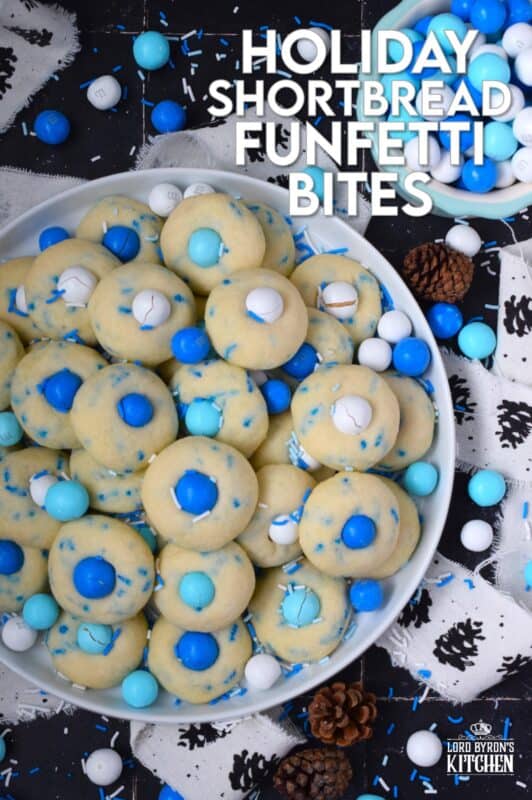Colourful and festive, these Holiday Shortbread Funfetti Bites are prepared with a whipped shortbread cookie dough base which is flavoured with vanilla extract. Loaded with sprinkles and topped with candy-coated chocolate, these are not only cute, but also the perfect one-bite holiday confection! #cookies #christmas #frozen #mandm #mms #sprinkles #funfetti
