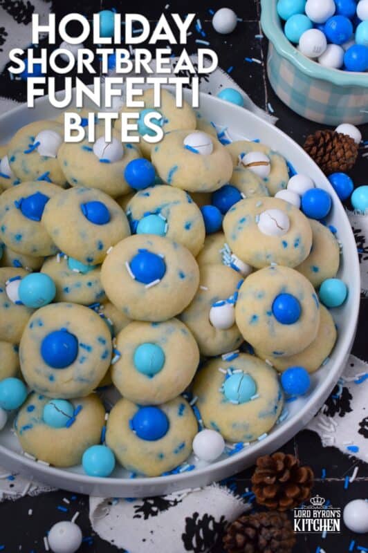 Colourful and festive, these Holiday Shortbread Funfetti Bites are prepared with a whipped shortbread cookie dough base which is flavoured with vanilla extract. Loaded with sprinkles and topped with candy-coated chocolate, these are not only cute, but also the perfect one-bite holiday confection! #cookies #christmas #frozen #mandm #mms #sprinkles #funfetti
