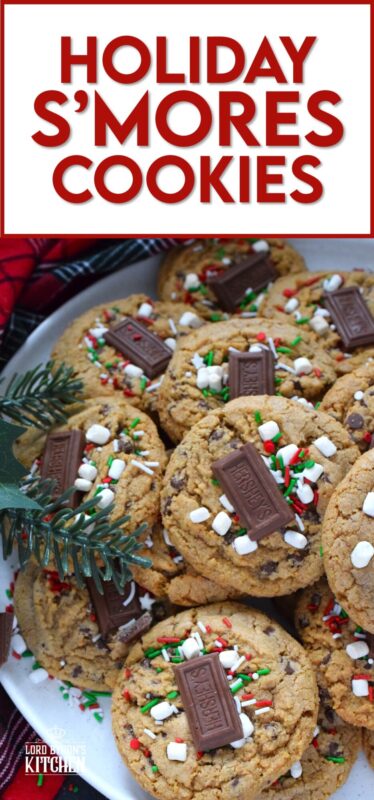 As the name implies, Holiday S'mores Cookies are prepared to resemble the flavour of everyone's favourite backyard fire treat! Baked with graham crumbs, chocolate, and brown sugar, these are a soft-baked cookie with a crispy edge. The texture of the crumbs with the milk chocolate is sensational. Topped with a bar of Hershey's chocolate, these cookies are a must this holiday season! #holiday #smores #cookies #christmas #baking