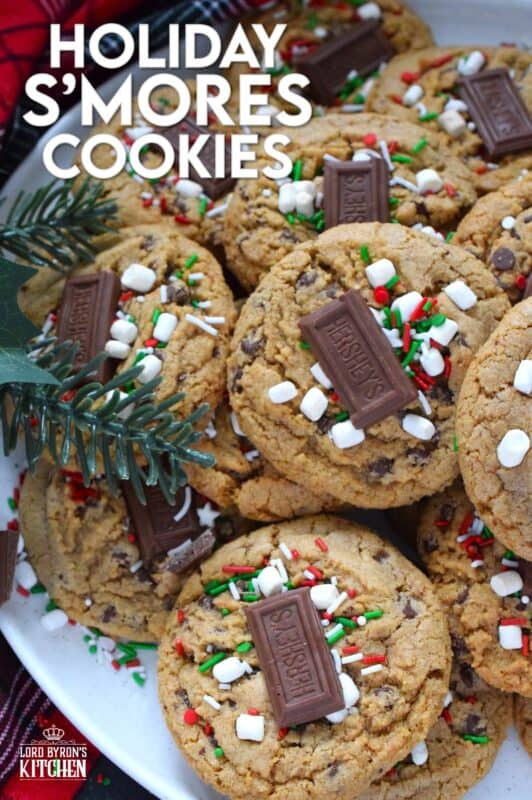 As the name implies, Holiday S'mores Cookies are prepared to resemble the flavour of everyone's favourite backyard fire treat! Baked with graham crumbs, chocolate, and brown sugar, these are a soft-baked cookie with a crispy edge. The texture of the crumbs with the milk chocolate is sensational. Topped with a bar of Hershey's chocolate, these cookies are a must this holiday season! #holiday #smores #cookies #christmas #baking