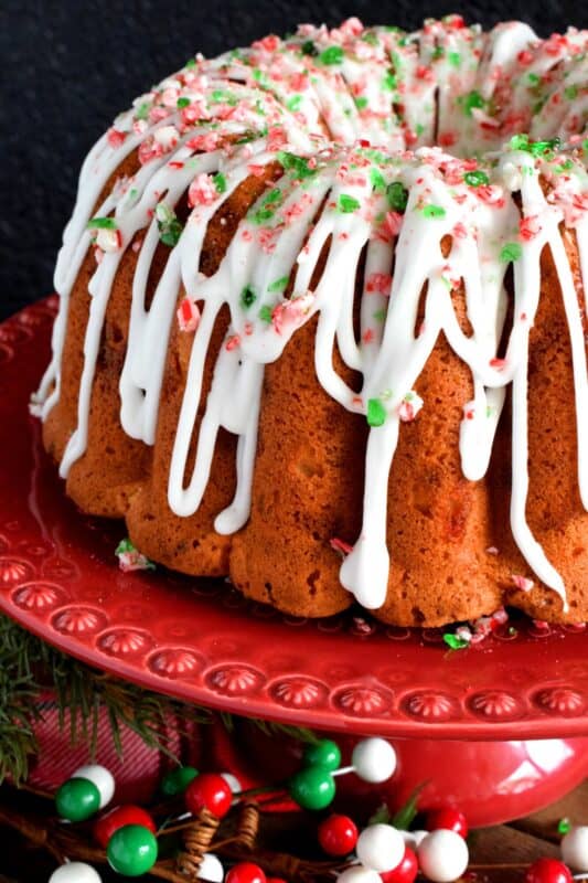 Peppermint is a dominant Christmastime flavour, so this candy cane bundt cake has a lot of it! With crushed candy canes baked into the cake batter and sprinkled over top a sweet and sugary glaze too, there's no shortage of peppermint flavour here! #candycane #peppermint #cake #bundt