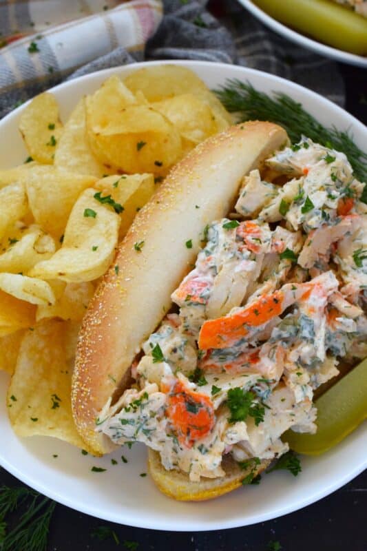 Loaded with crab meat, these Crab Salad Rolls are a fast and easy meal that is easily completed with a handful of really crispy kettle chips! The crab meat is tossed in a savoury thick dressing made with mayonnaise, chives, dill, lemon, and celery. It really does not get any easier or any more delicious than this! #crab #imitation #salad #sandwich #rolls