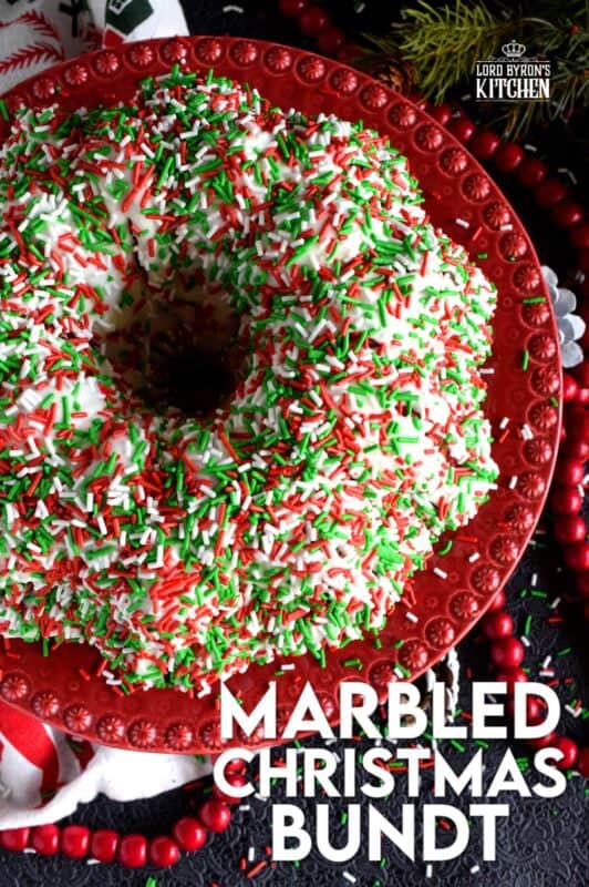 Kids of all ages will love a big slice of this Marbled Christmas Bundt Cake. This cake is festive, colourful, merry, and bright! It's made with yogurt so it will stay beautifully soft and moist. And, no matter what your age, everyone loves sprinkles! #bundt #sprinkles #marble #christmas #cake