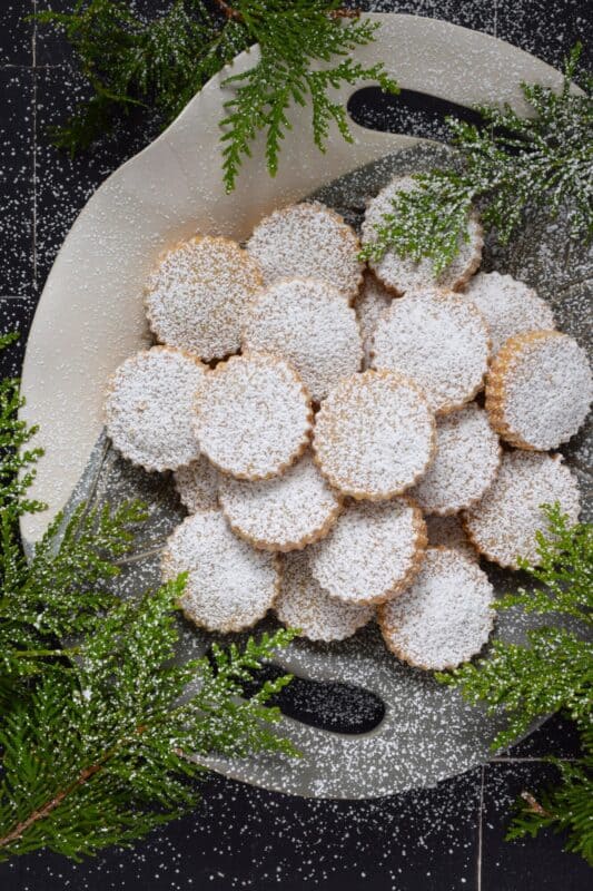 If it's a bang for your buck you want, these Spanish Almond Polvorones are just the thing! And it doesn't get any simpler than butter, sugar, all-purpose flour, almond flour, and cinnamon. Don't bother with fancy decoration! Dust these cookies with confectioner's sugar only because perfection doesn't need to be prettied! #polvorones #spanish #cookies #christmas