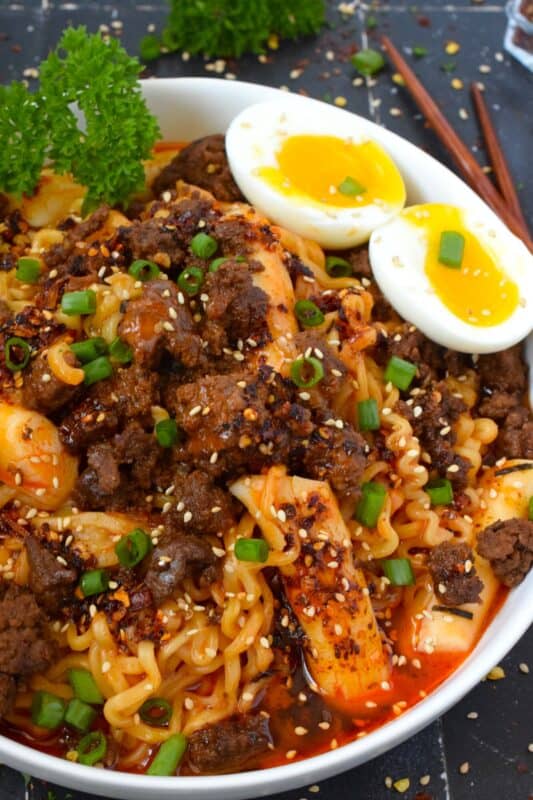 This dish has it all - noodles, ground beef, broth, soft-boiled egg, and even rice cakes! Firecracker Beef Ramen Noodles starts with a quick, easy, and spicy pan-fried ground beef that is paired with store-bought packaged ramen noodles and optional Korean rice cakes! This is one of those warm and cozy recipes perfect for a night in binging on your new favourite television series! #ramen #groundbeef #beef #ricecakes #soup #korean