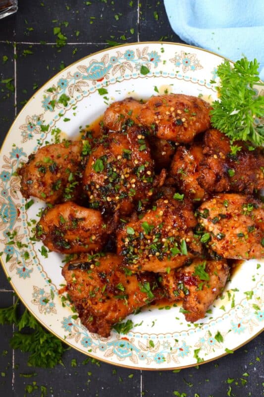 Moist and tender, Fried Chili Soy Chicken Thighs are marinated and pan-fried until crispy and drizzled with a homemade chili sauce easily prepared with brown sugar, chilies, vinegar, and sesame oil. #chicken #asian #fried #spicy #thighs