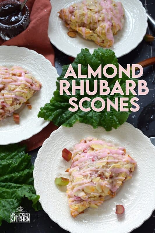 Puckeringly tart rhubarb is mellowed in these slightly sweet Almond Rhubarb Scones. Prepared with a splash of vanilla extract and crunchy sliced almonds, these are an absolute delight. Topped with a sweet pink glaze made with grenadine, they're just beautiful! #scones #rhubarb #grenadine #glaze