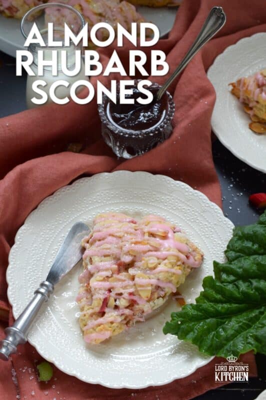 Puckeringly tart rhubarb is mellowed in these slightly sweet Almond Rhubarb Scones. Prepared with a splash of vanilla extract and crunchy sliced almonds, these are an absolute delight. Topped with a sweet pink glaze made with grenadine, they're just beautiful! #scones #rhubarb #grenadine #glaze