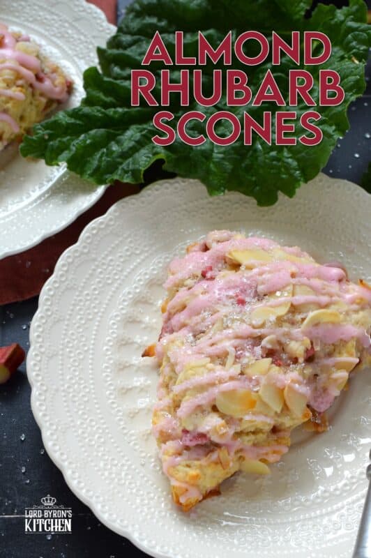 Puckeringly tart rhubarb is mellowed in these slightly sweet Almond Rhubarb Scones. Prepared with a splash of vanilla extract and crunchy sliced almonds, these are an absolute delight. Topped with a sweet pink glaze made with grenadine, they're just beautiful! #scones #rhubarb #grenadine #glaze
