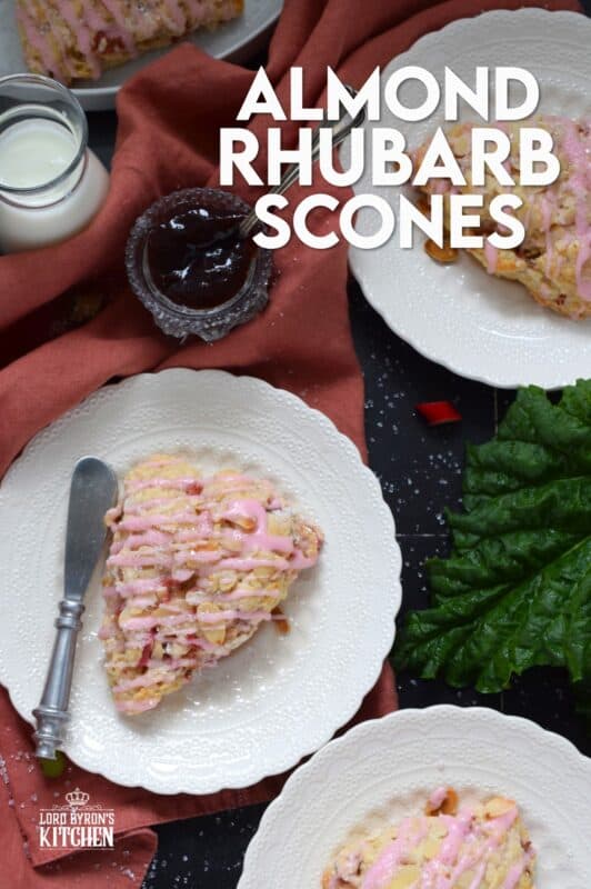 Puckeringly tart rhubarb is mellowed in these slightly sweet Almond Rhubarb Scones. Prepared with a splash of vanilla extract and crunchy sliced almonds, these are an absolute delight. Topped with a sweet pink glaze made with grenadine, they're just beautiful! #scones #rhubarb #grenadine #glaze