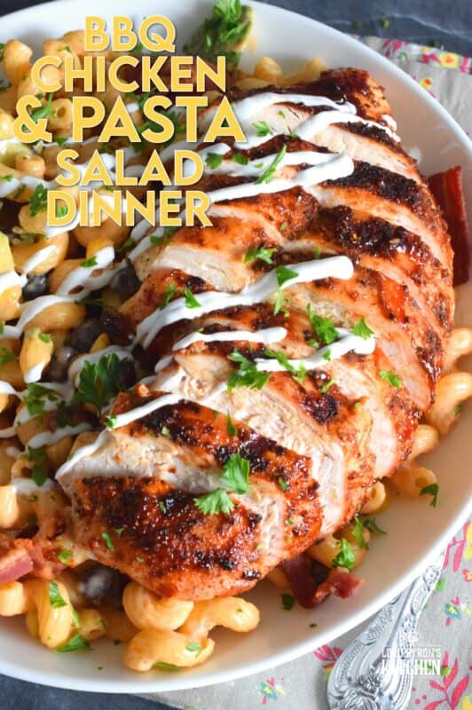 Spice-seasoned chicken breasts are grilled to perfection and then brushed with BBQ sauce and served with a delicious pasta salad prepared with bacon, avocado, corn, black beans, green onions, and roasted red peppers.  This pasta salad dinner is a hearty meal great for any backyard family picnic! #bbq #chicken #pasta #salad #dinner