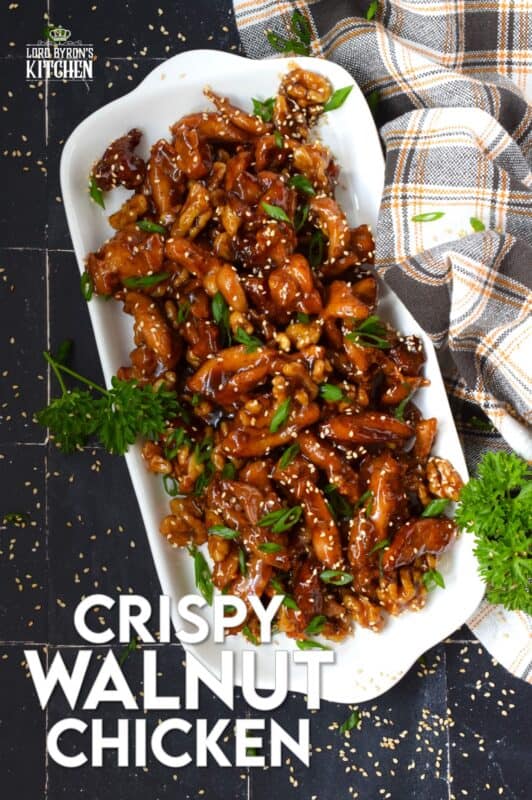 Quite a popular dish at almost every North American Chinese buffet, Crispy Walnut Chicken is prepared with moist and tender boneless and skinless chicken thighs. The chicken is coated and fried until crispy then tossed in a sweet sauce made with honey, soy, sesame, and of course, walnuts! #friedchicken #chicken #sweet #soy #walnut