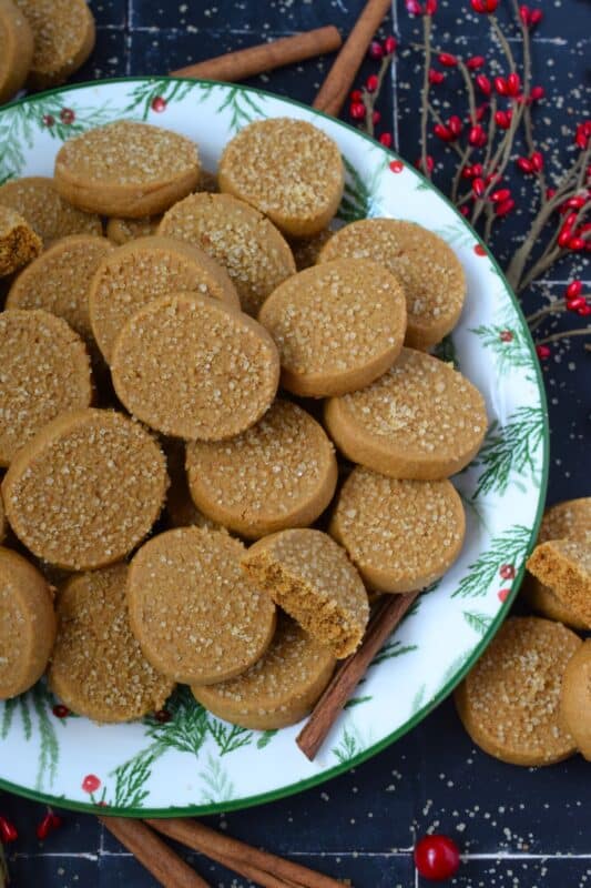 With a slightly crispy outer edge and a chewy center, Cinnamon Ginger Cookies are topped with a sprinkling of caramelly turbinado sugar. These cookies are warming to the taste because of the mild heat produced by the cinnamon and ginger. Serve these with hot tea or coffee for a delightful little treat! #molasses #cinnamon #ginger #cookies
