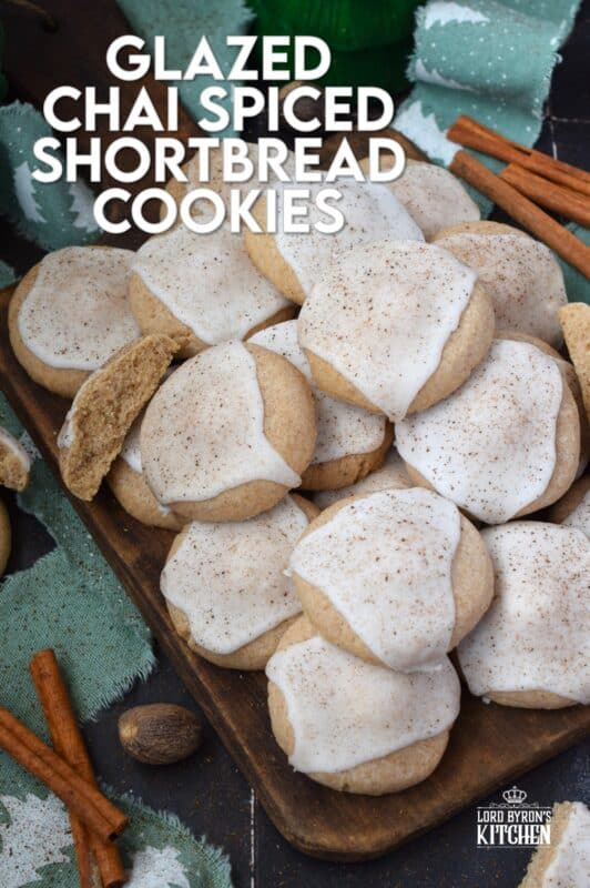 Glazed Chai Spiced Shortbread Cookies are buttery, light, and airy. The cookies are infused with familiar chai spices like cinnamon, nutmeg, ginger, cloves, and cardamom. Once cooled, the cookies are flooded with a delightfully smooth and sweet glaze; these cookies are bound to be a holiday favourite! #chai #cookies #cardamom #glazed #christmas