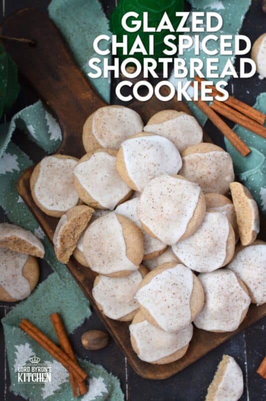 Glazed Chai Spiced Shortbread Cookies are buttery, light, and airy. The cookies are infused with familiar chai spices like cinnamon, nutmeg, ginger, cloves, and cardamom. Once cooled, the cookies are flooded with a delightfully smooth and sweet glaze; these cookies are bound to be a holiday favourite! #chai #cookies #cardamom #glazed #christmas